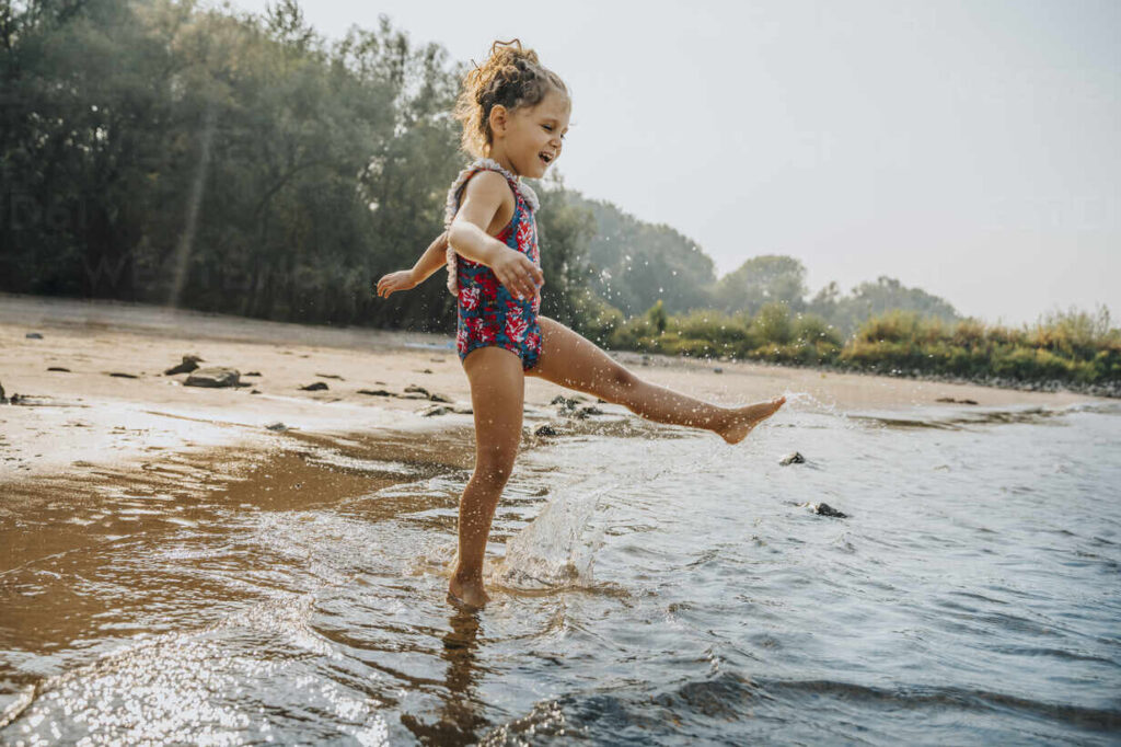 Girl Enjoying The Water At A Beach, Cologne, Nrw, Germany